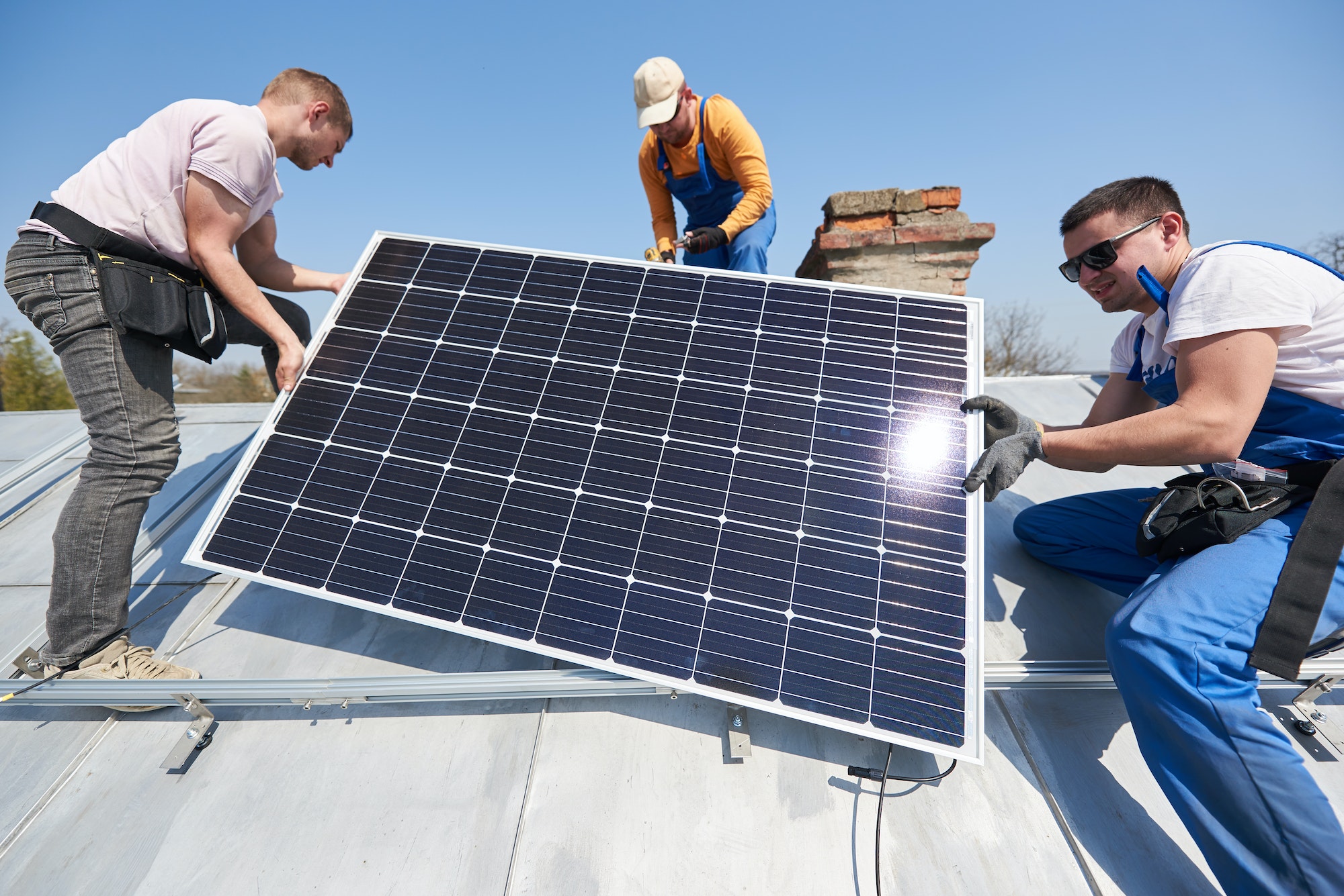 installing-solar-photovoltaic-panel-system-on-roof-of-house.jpg